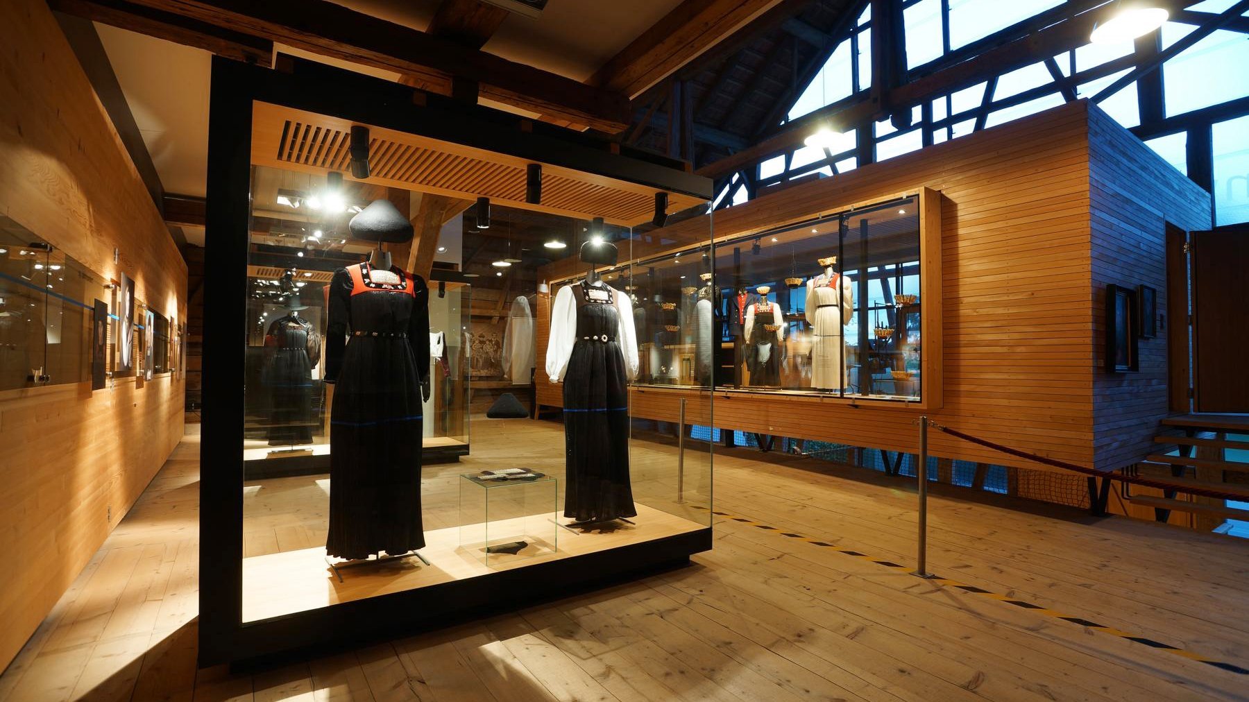 Inviting Exhibition Space at Hirschen Wohlfühlhotel Exhibition space featuring glass cases of traditional clothing and artifacts in a hotel interior